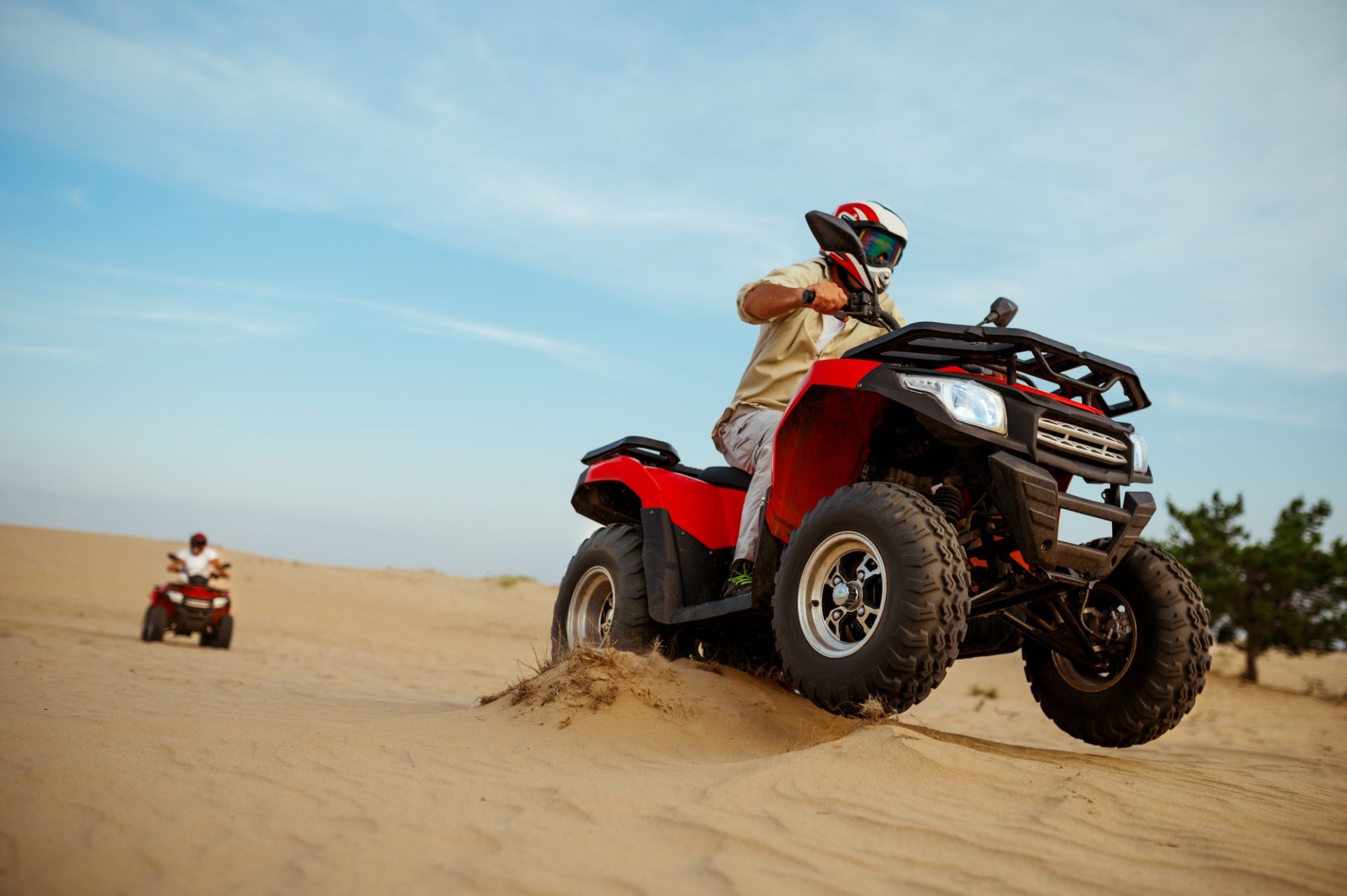 two-men-in-helmets-ride-on-atv-action-view-1-e1644355840783.jpg